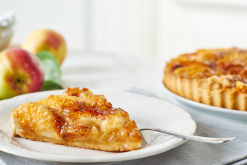 Piece of homemade french apple tart on dish