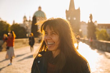 woman portrait at sunrise with messy hair because of wind
