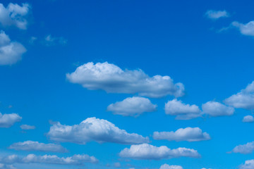 White clouds in the blue sky. Beautiful nature background. Freedom, nature, landscape concept.