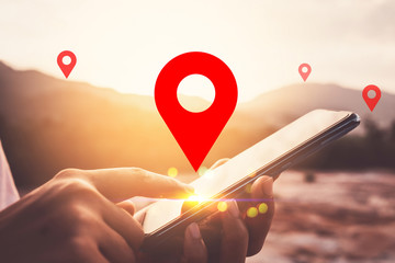 Woman hand using smart phone on top of mountain with navigator location point abstract background....