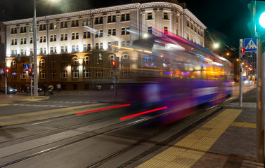 Fototapeta na wymiar The motion of a blurred tram in the evening.