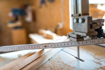 Wood measurer on band saw table , cutted wood pieces, shallow depth of field, copy space.