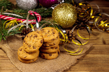Chocolate chip cookies with Christmas decoration on wooden table