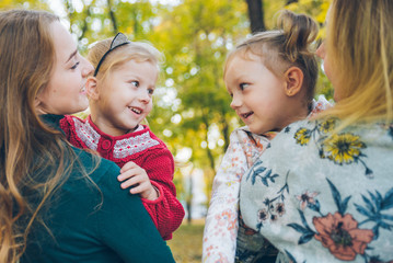 mother daughter love hug at autumn city park