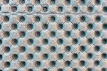 Texture of polyethylene a gray travel mat. Patterns of round dimples and rises