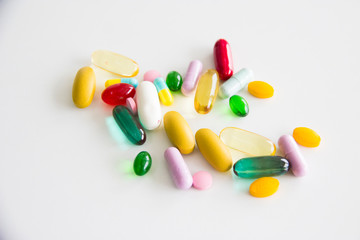 colorful Assorted pharmaceutical medicine pills, tablets and capsules on the white table