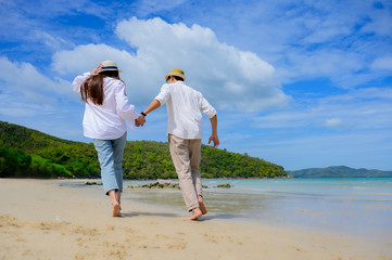 Couple lover enjoy running together on the sea beach, same direction of life go ahead together future