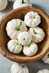White little pumpkins in a wooden bowl