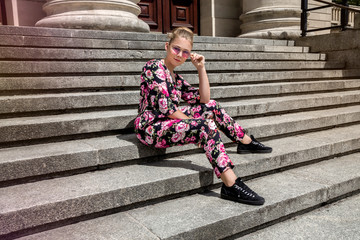 Fashionable stylish beautiful young model in summer autumn floral clothes posing in the street - Image