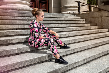 Fashionable stylish beautiful young model in summer autumn floral clothes posing in the street - Image