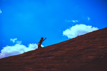silhouette of businessman with  mountain top,Business people are climbing to the top of the mountain and looking ahead, business, success, Concept vision,