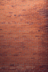 Fototapeta na wymiar Red bricks background. A part of wall of the building