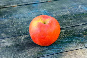 One ripe apples on a wooden table