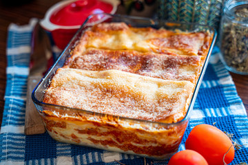 Tasty Homemade Lasagne with Meat and Parmesan Cheese. Traditional Italian Lasagna with Vegetables, Basil, Minced Beef Meat, Tomato Sauce and Cheese