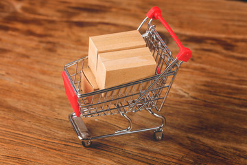 shopping online at home concept.Cartons in a shopping cart on a laptop keyboard
