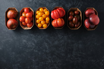 Different types of tomatoes in paper packaging
