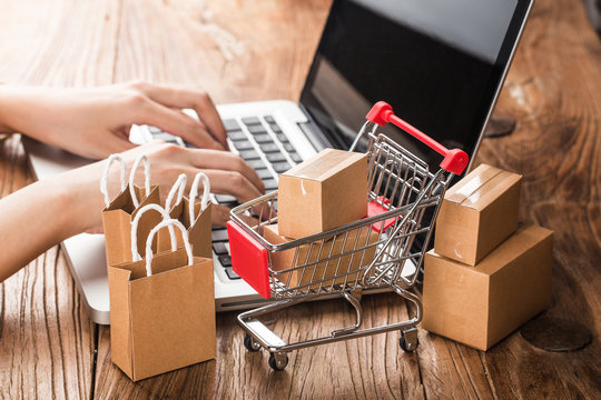 shopping online at home concept.Cartons in a shopping cart on a laptop keyboard