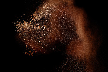 Freeze motion of brown dust explosion.Stopping the movement of brown powder. Explosive brown powder...