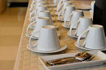 Close up empty glasses set and spoon in plate on table in restaurant.
