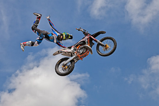 Premium Vector, Motocross rider doing jumping whip trick