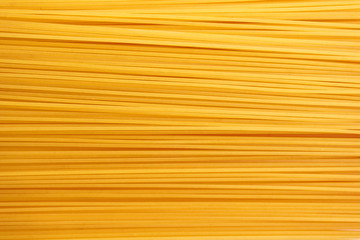 Uncooked spaghetti background, top view. Texture of pasta, closeup. Food background, banner