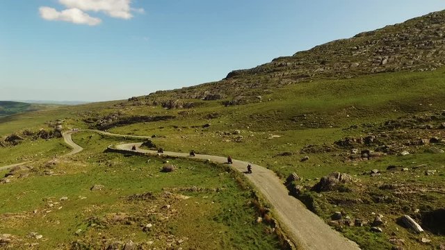 Bikers on dirt road in Irish countryside, aerial