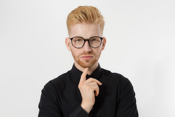 Young entrepreneur Generate Business Ideas. Close up of thinking Man in black shirt and glasses isolated, copy space. Self improvement, serious male face. Redheaded guy with red beard, hairstyle