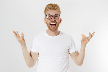 Man Depression signs and Symptoms. Young redheaded guy with red beard and white t shirt shouting hard and angry. Failed startup and fail exam concept. Unhappy businessman with aggressive feelings.