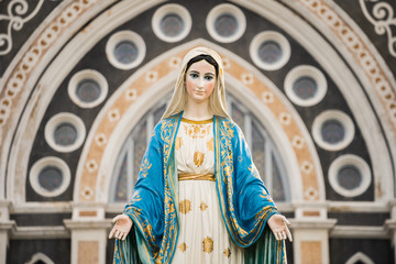 The Blessed Virgin Mary,mother of Jesus on the blue sky, in front of the Roman Catholic Diocese,...