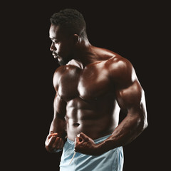 Fototapeta na wymiar Handsome african fittness model displaying his abdominals