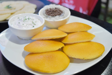 Sweet pancakes made from flour with sweet sauce on plate in restaurant.
