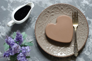 Chocolate panna cotta with chocolate sauce and nuts