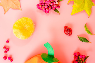 Pink background with fruits and autumnal motifs, empty center to include text, with funny pumpkin.