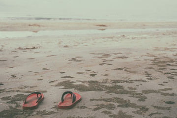 Obraz premium Red shoes on the beach on daylight