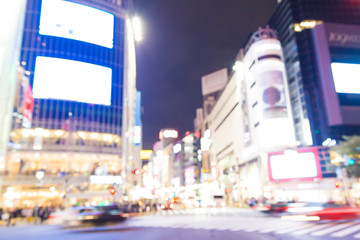 Blurred night traffic movement and people walking in Shibuya Tokyo town
