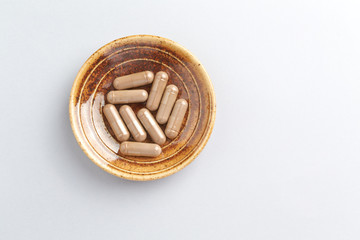 Reishi Mushroom Extract. Concept for a healthy dietary supplementation. White background. Top view. Close up. 