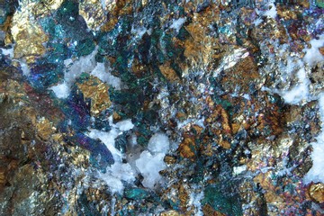 Stone macro of a Chalkopyrit with beautiful colors and small crystals
