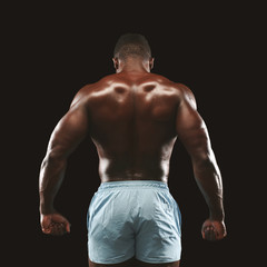 Fototapeta premium African american sportsman showing strong back muscles
