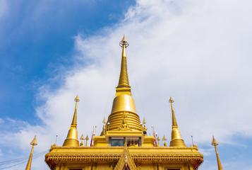 Fototapeta premium The top of the golden pagoda in the blue sky.
