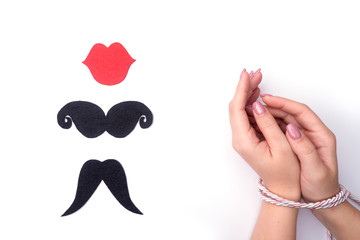 Sibari female hands Japanese art, fashionable nail care, tied with a rope on a white background view from the top with the elution of a person in the form of a symbol.