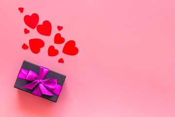 gifts with heart-shaped confetti on pink background top view mockup