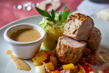 Plate with delicate pork tenderloin with vegetable mash potatoes and sauce