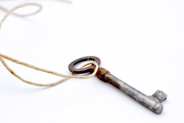 old rusty key on white background