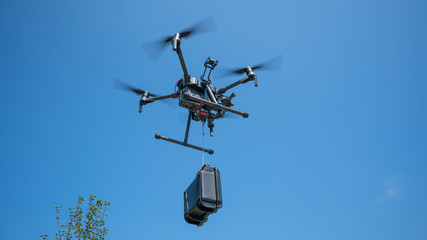 Fototapeta na wymiar Drone carrying supplies 