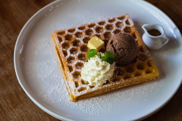 chocolate ice cream, soft cream, cheese on waffle in the white plate