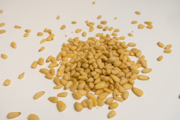 pine nuts on a white plate and in a transparent plate
