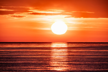 Beautiful red and orange sunset over the sea. The sun goes down over the sea.
