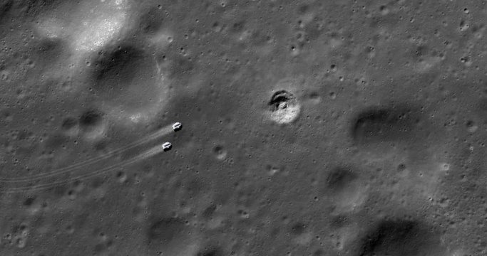 High-altitude aerial of two surface exploration vehicles travelling across the moon's surface. Elements of this image furnished by NASA