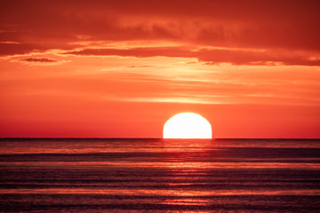 Fototapeta na wymiar Beautiful red and orange sunset over the sea. The sun goes down over the sea.