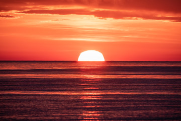 Beautiful red and orange sunset over the sea. The sun goes down over the sea.